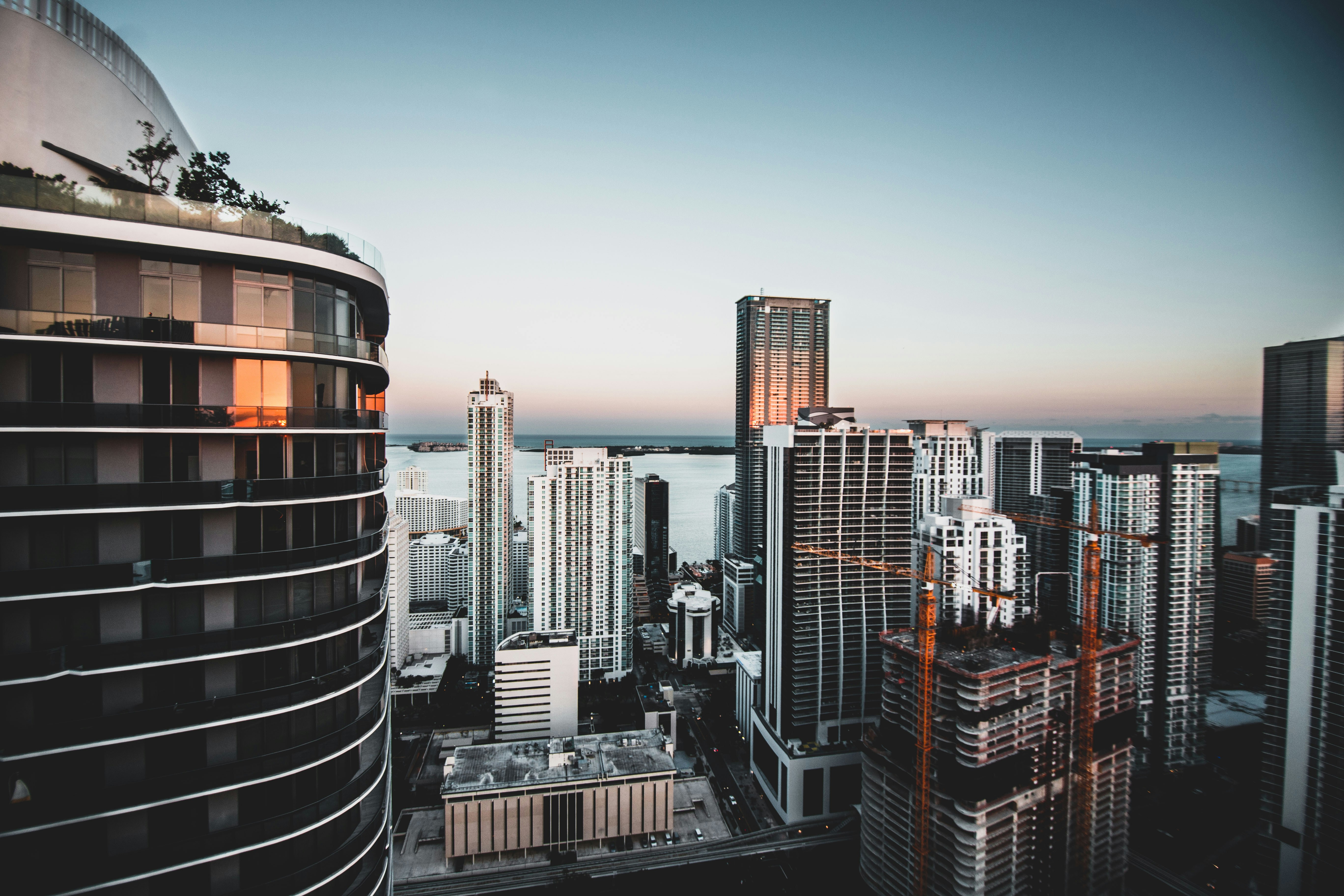 Elevated view over Brickell rooftops toward the bay at dusk